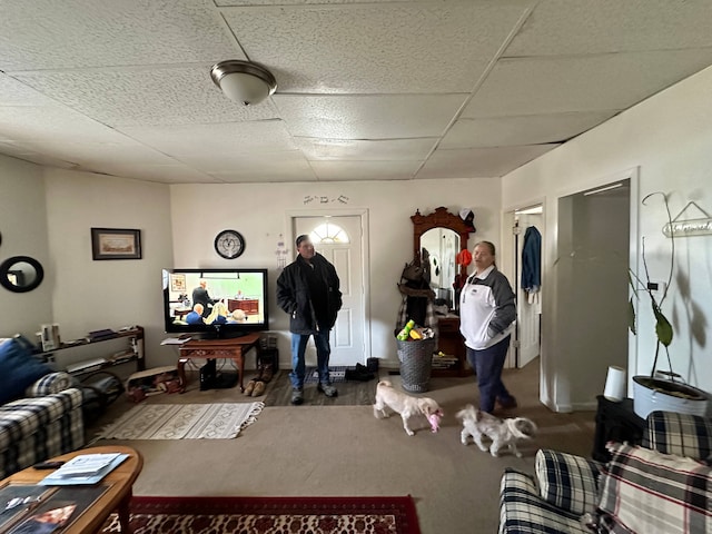 living room with a drop ceiling and dark hardwood / wood-style flooring