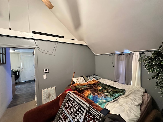 bedroom with lofted ceiling and wood-type flooring