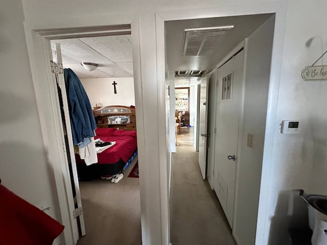 hallway with light colored carpet