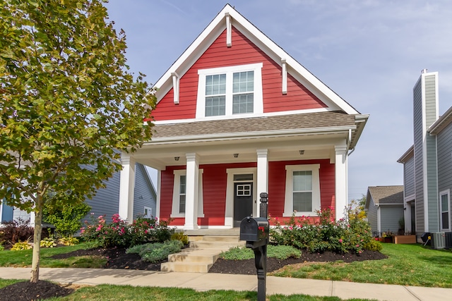 view of front facade featuring a porch and central AC