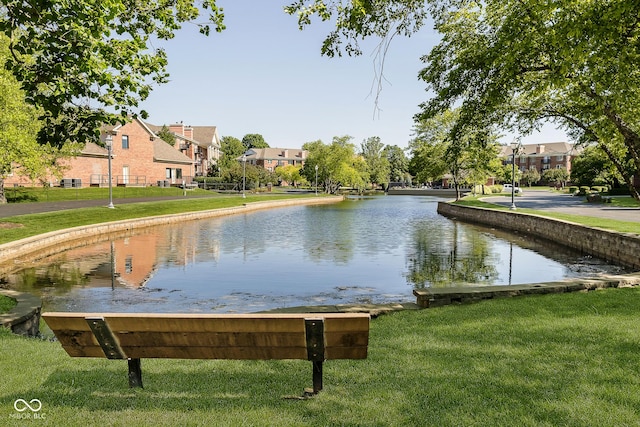 view of property's community with a yard and a water view