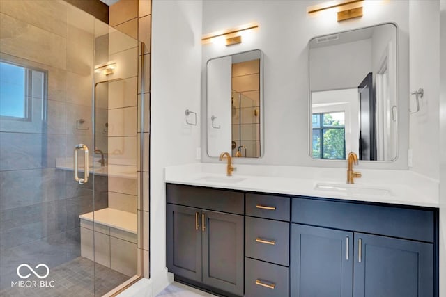 bathroom with vanity and a shower with shower door