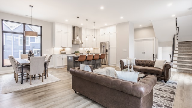 living room with sink and light hardwood / wood-style floors