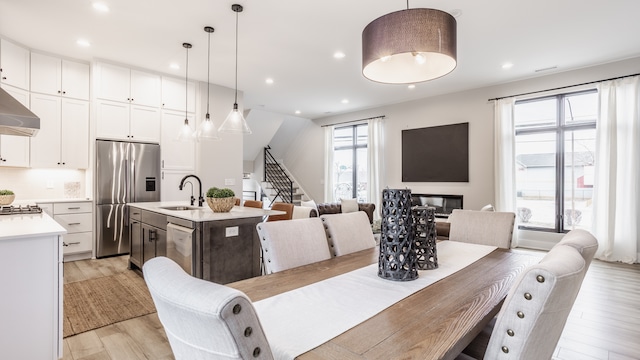 dining space featuring sink and light wood-type flooring