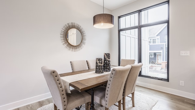 dining space with hardwood / wood-style flooring