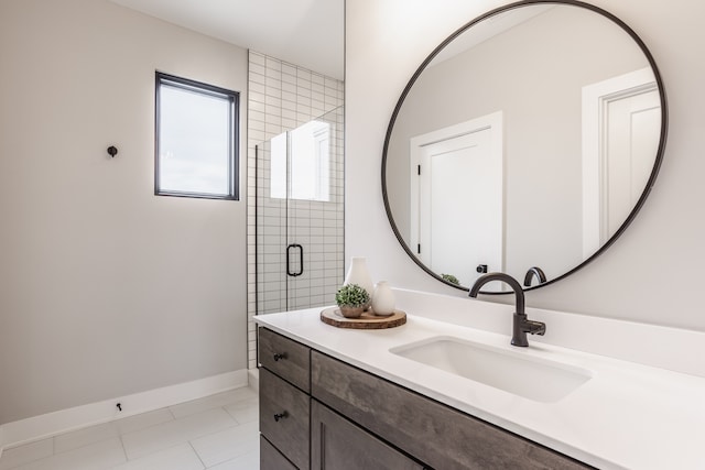 bathroom featuring tile floors, a shower with door, and vanity