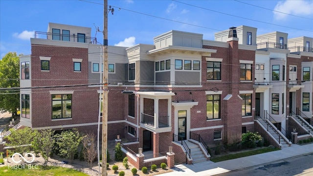 view of front of home featuring a balcony