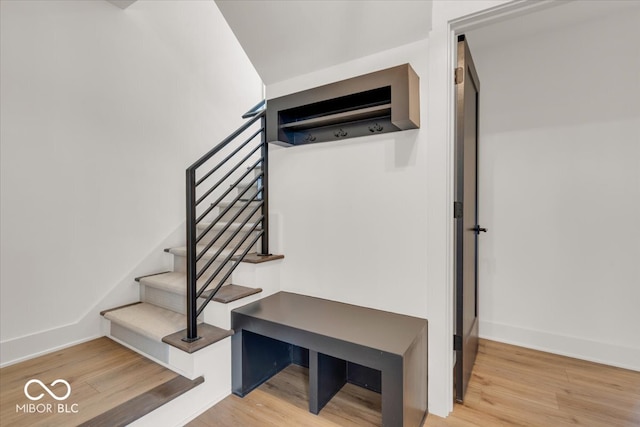 stairs featuring hardwood / wood-style flooring