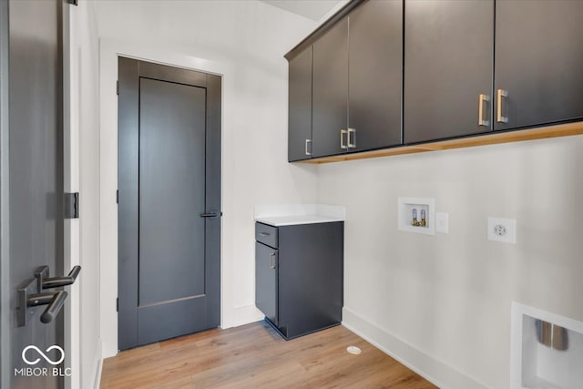 laundry area with washer hookup, light hardwood / wood-style flooring, cabinets, and electric dryer hookup