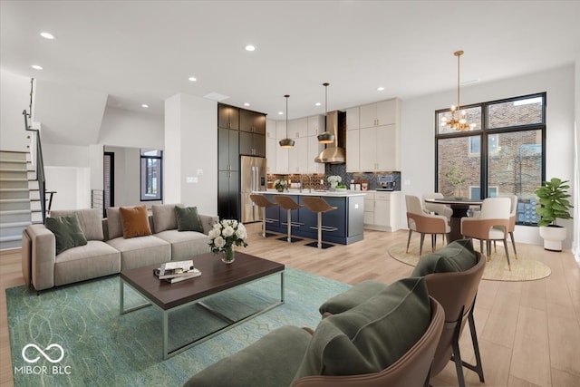 living room featuring a notable chandelier and light hardwood / wood-style floors