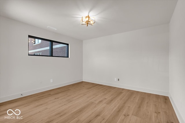 unfurnished room with light wood-type flooring