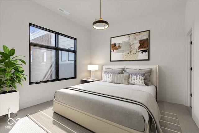 bedroom featuring light colored carpet