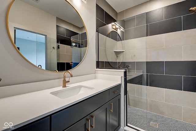 bathroom with a walk in shower and vanity