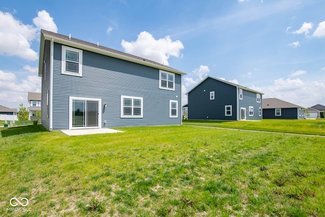 back of house featuring a patio area and a yard