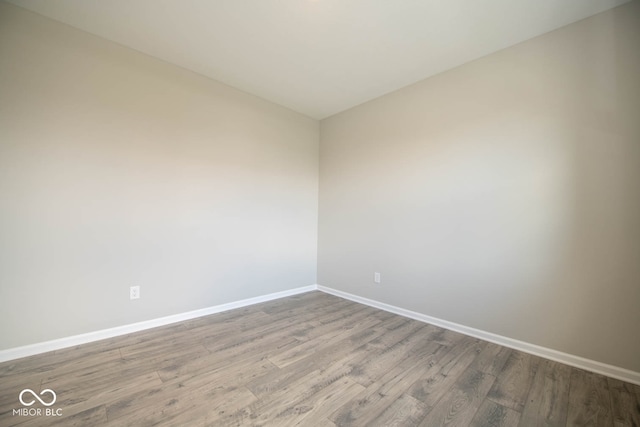 unfurnished room with hardwood / wood-style floors