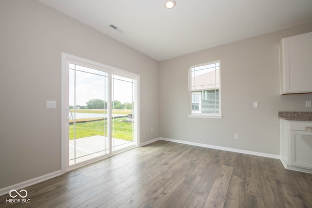 unfurnished living room featuring a healthy amount of sunlight and hardwood / wood-style flooring