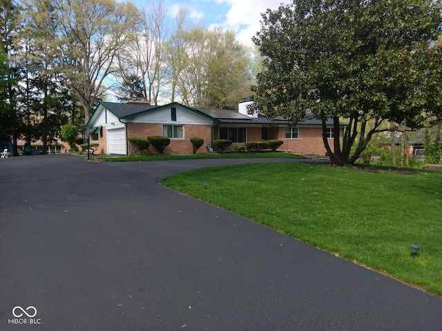 ranch-style home with a garage and a front yard