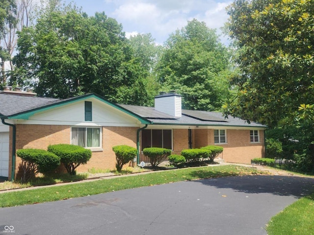 ranch-style house with solar panels