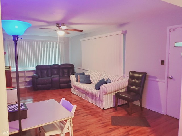 living room featuring hardwood / wood-style flooring and ceiling fan