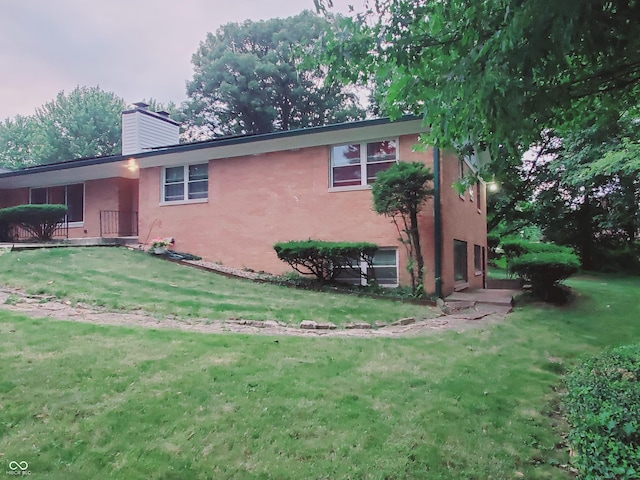 rear view of property with a yard