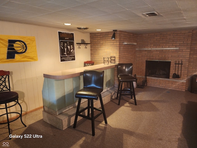 bar with carpet flooring and a brick fireplace