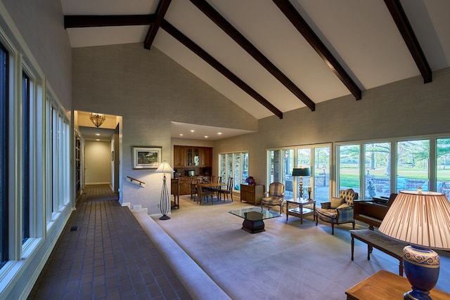 unfurnished living room with beamed ceiling, high vaulted ceiling, and carpet floors