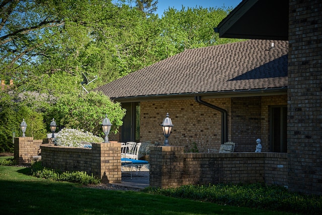 exterior space featuring a patio area and a lawn