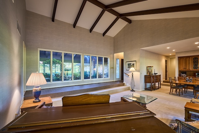 living room with high vaulted ceiling and beam ceiling