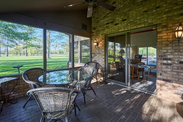 sunroom featuring vaulted ceiling and ceiling fan