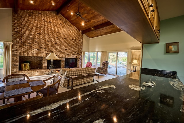 living room with wooden ceiling, a fireplace, high vaulted ceiling, and beamed ceiling