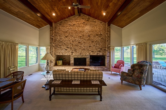 carpeted living room with wood ceiling, a wealth of natural light, high vaulted ceiling, and a brick fireplace