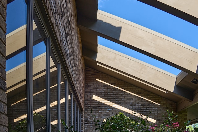 exterior details featuring beamed ceiling