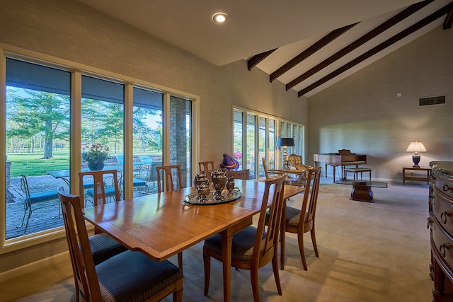 dining area with beamed ceiling and high vaulted ceiling