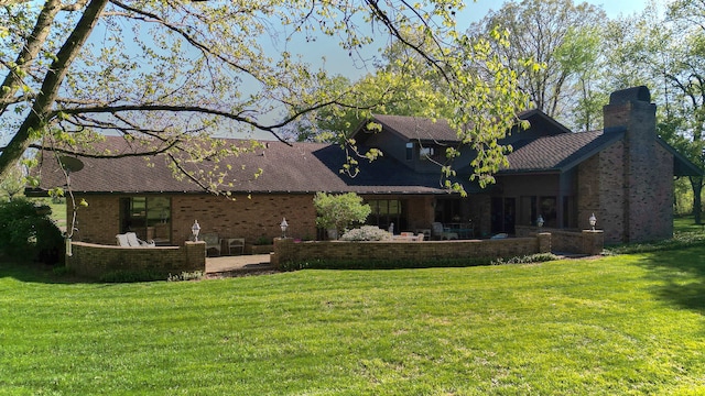 back of house featuring a patio and a lawn