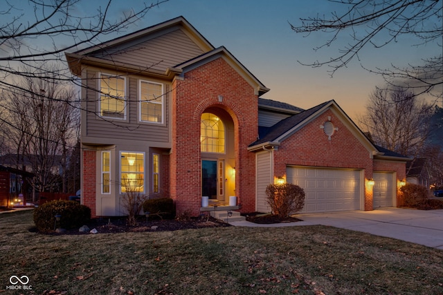 view of property featuring a garage and a lawn