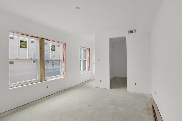 unfurnished room featuring concrete floors