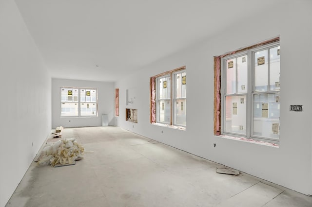 unfurnished room with concrete flooring