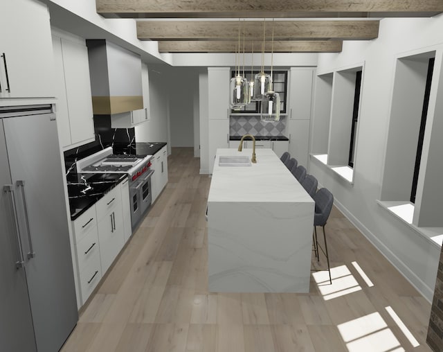 kitchen featuring an island with sink, beamed ceiling, sink, and light hardwood / wood-style floors