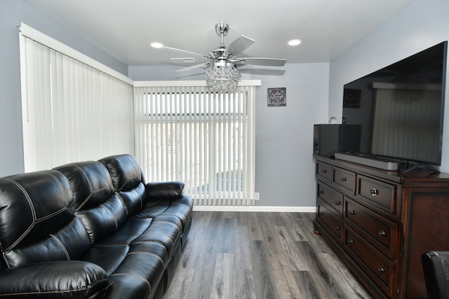 living room with ceiling fan and dark wood-type flooring