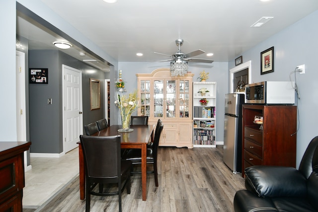 dining room featuring ceiling fan and light hardwood / wood-style flooring