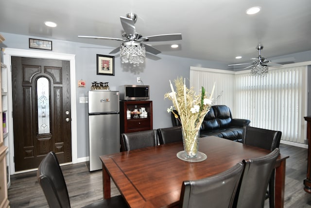 dining area with ceiling fan and dark hardwood / wood-style floors