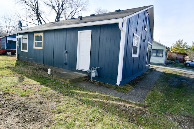 view of side of home with a lawn