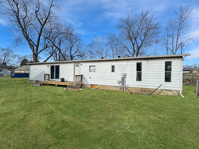 back of property featuring a lawn