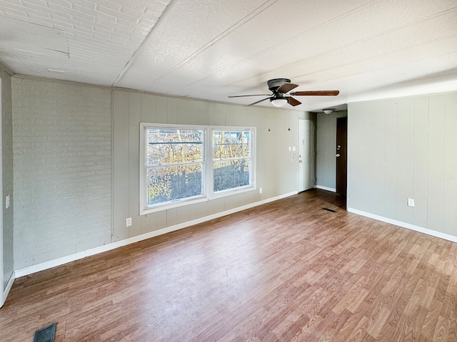 unfurnished room featuring dark wood-type flooring, ceiling fan, and a textured ceiling