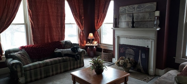 sitting room featuring light colored carpet and a brick fireplace