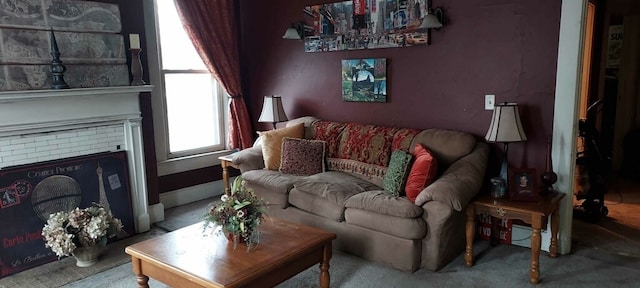 carpeted living room featuring a brick fireplace