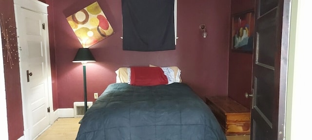 bedroom featuring light hardwood / wood-style floors and a closet