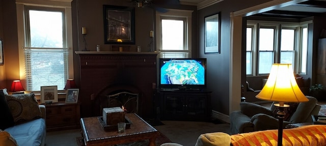 living room featuring ceiling fan and a wealth of natural light