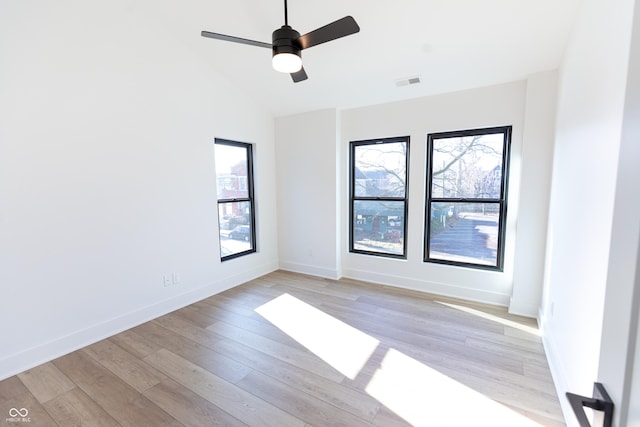 spare room featuring ceiling fan, light hardwood / wood-style floors, and vaulted ceiling