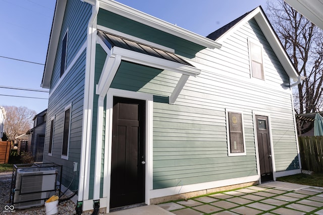 2133 N Talbott St, Indianapolis, IN 46202 - rear view of house featuring a standing seam roof, a patio, and a metal roof